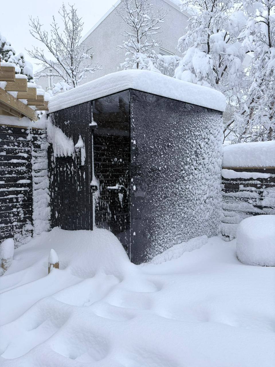 Real Wood Architects panoramic cube sauna after heavy snowfall