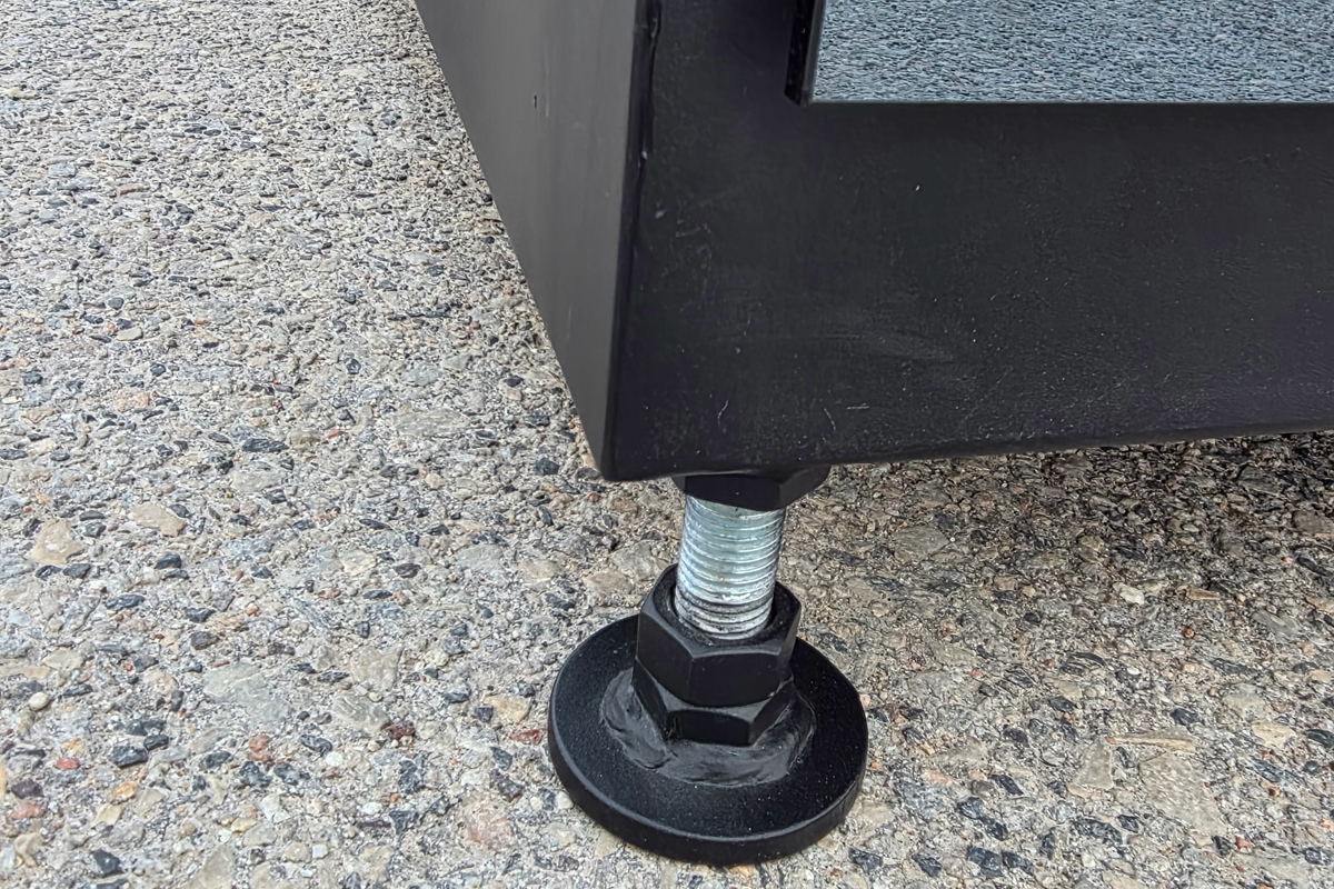 Adjustable levelling foot and base detail on a real prefabricated cube sauna.