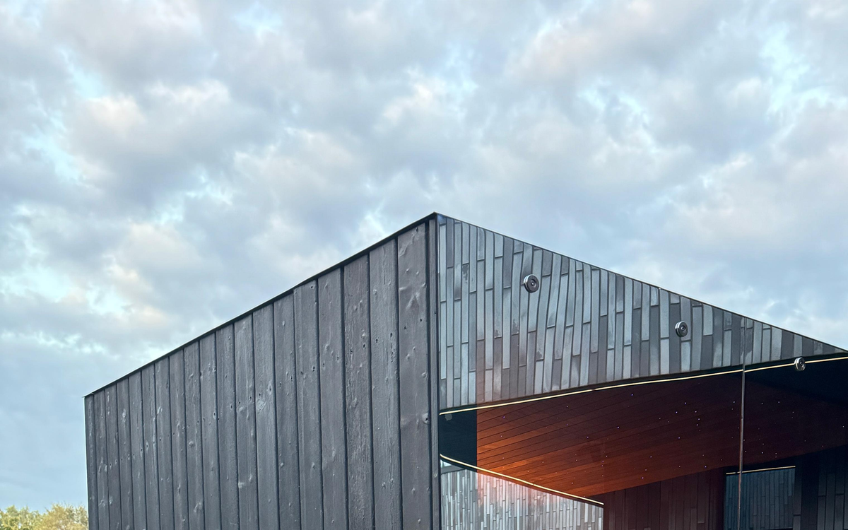 Photographed finished upper sauna envelope with glazing and timber cladding.