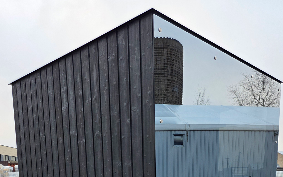 Reflective panoramic sauna glazing showing direct and reflected sightline context.