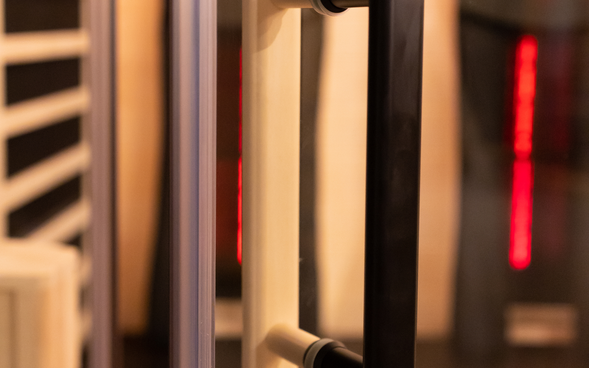 Real sauna glass door and handle viewed as a physical interface.