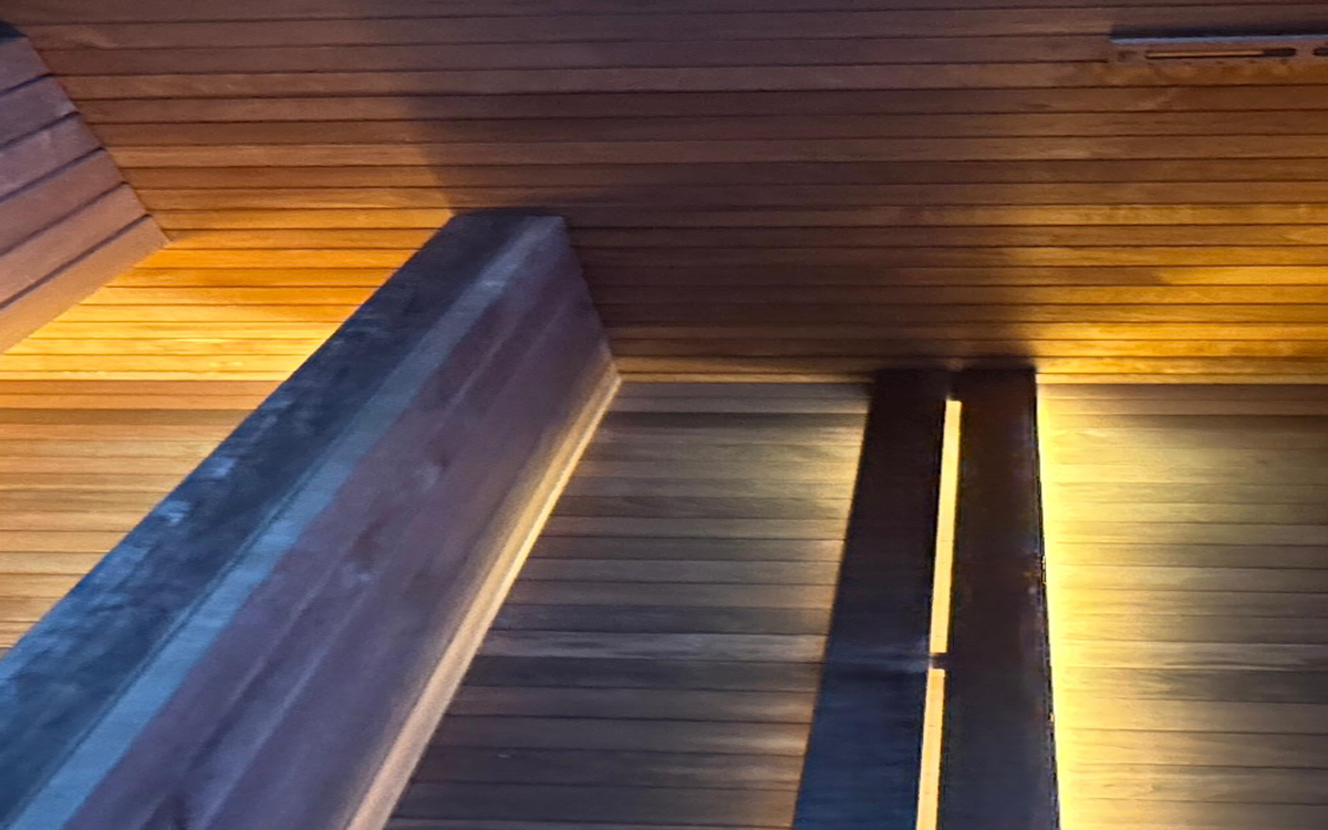 Real sauna timber surfaces visible during an operator reset.