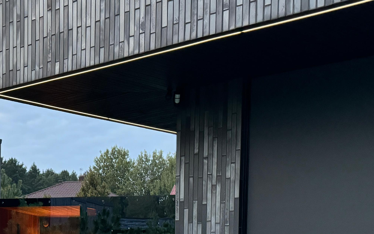 Real architectural canopy and roofline beside a modern sauna context.