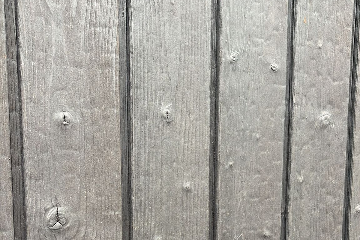 Close view of a weathered grey timber material surface.