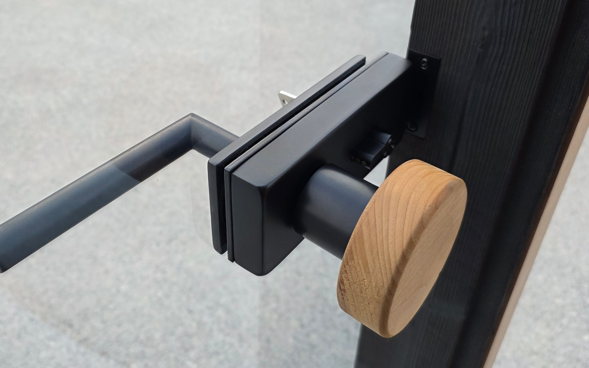 Photographed glass-door hardware and timber interface shown only as physical coordination context.
