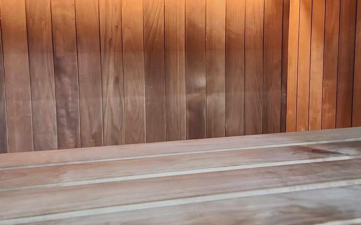 Real modern sauna interior showing one timber bench zone.
